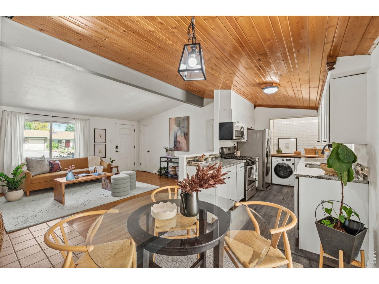 Dedicated dining space with custom wainscoting walks out to the covered back deck.