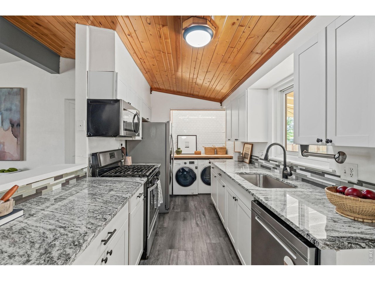 Coffee bar and laundry nook tucked behind the kitchen, equal parts pretty and practical.
