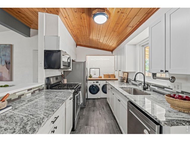 Property Photo 11 Coffee bar and laundry nook tucked behind the kitchen, equal parts pretty and practical.