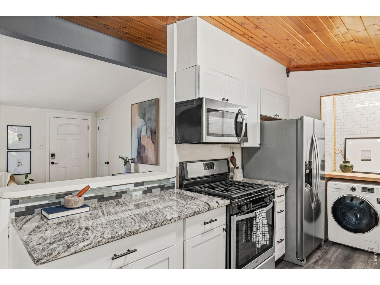 Open sightlines from kitchen to living room means you never miss a moment.