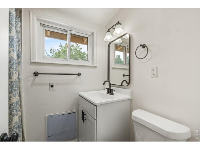 Property Photo 24 Refreshed second bathroom with new vanity, new fixtures, and a clean modern feel.