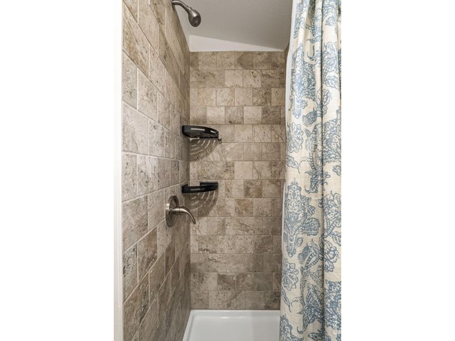 Property Photo 23 Refreshed second bathroom with new vanity, new fixtures, and a clean modern feel.