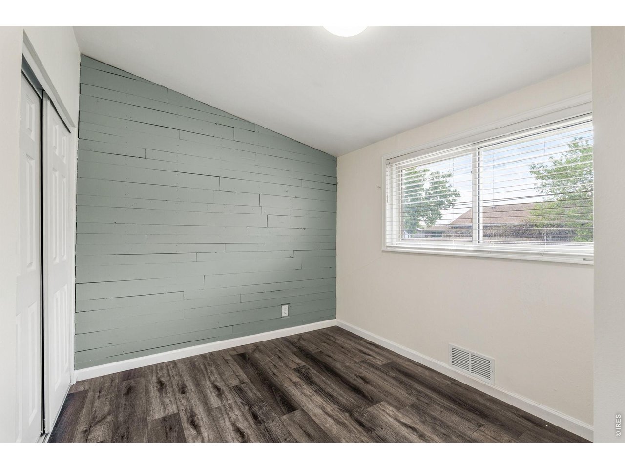 Sage shiplap accent wall makes this room ideal for a nursery, guest room, or home office.