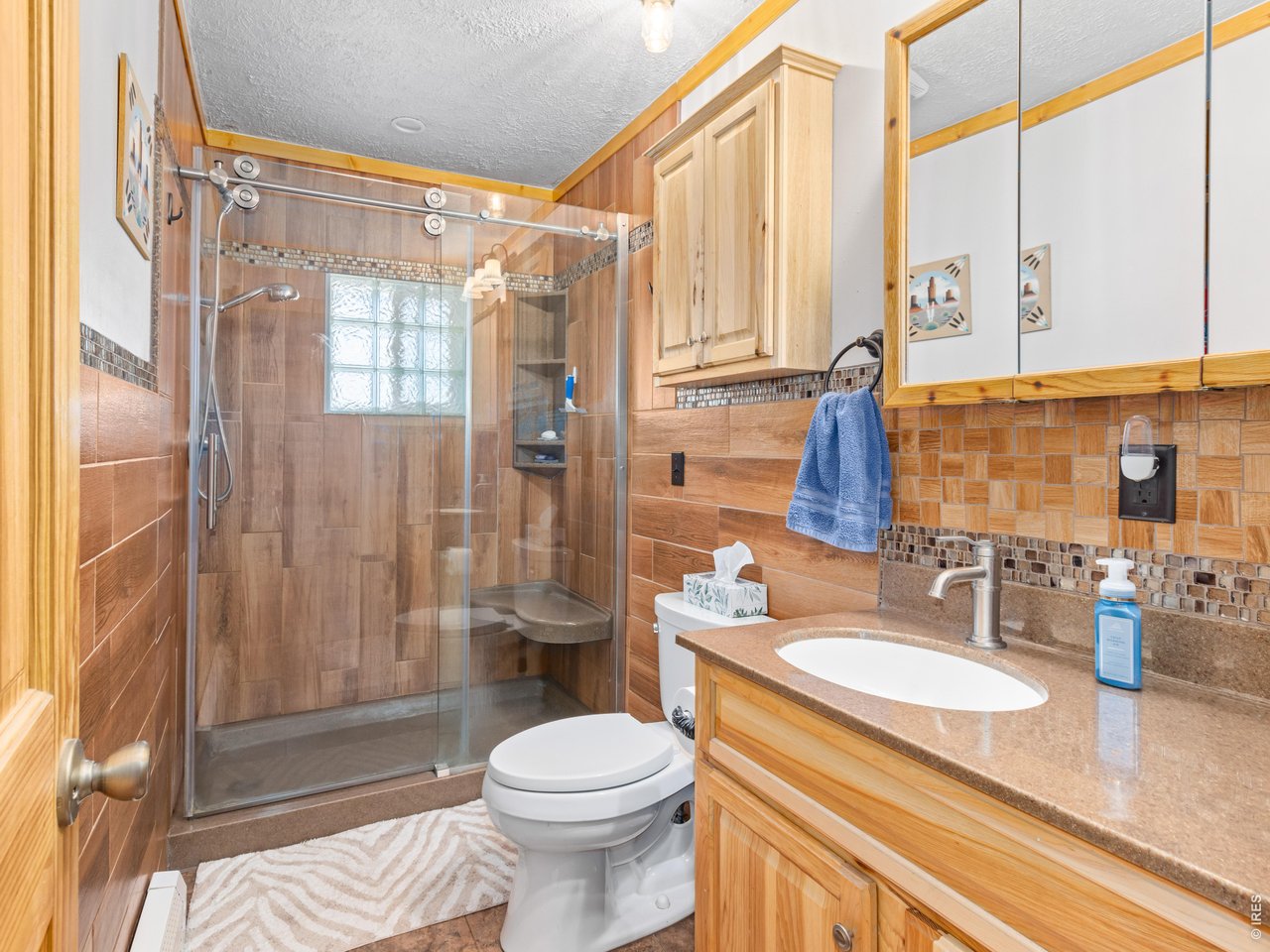 Property Photo 19 Main bathroom featuring a Corian countertop and Hickory cabinets