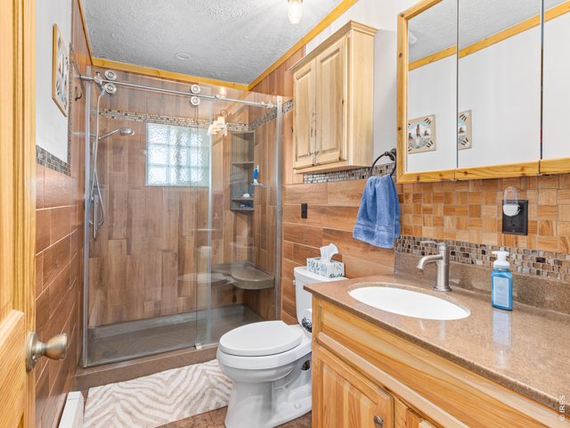 Property Photo 19 Main bathroom featuring a Corian countertop and Hickory cabinets
