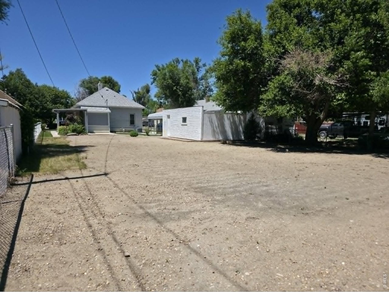 Back yard is fully fenced on three sides, Just needs fencing along the driveway and back patio