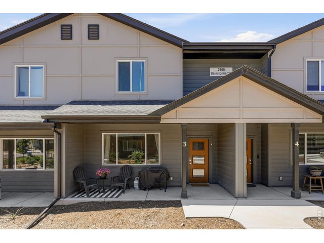 Property Photo 3 A charming front patio welcomes you into a bright, open-concept floor plan