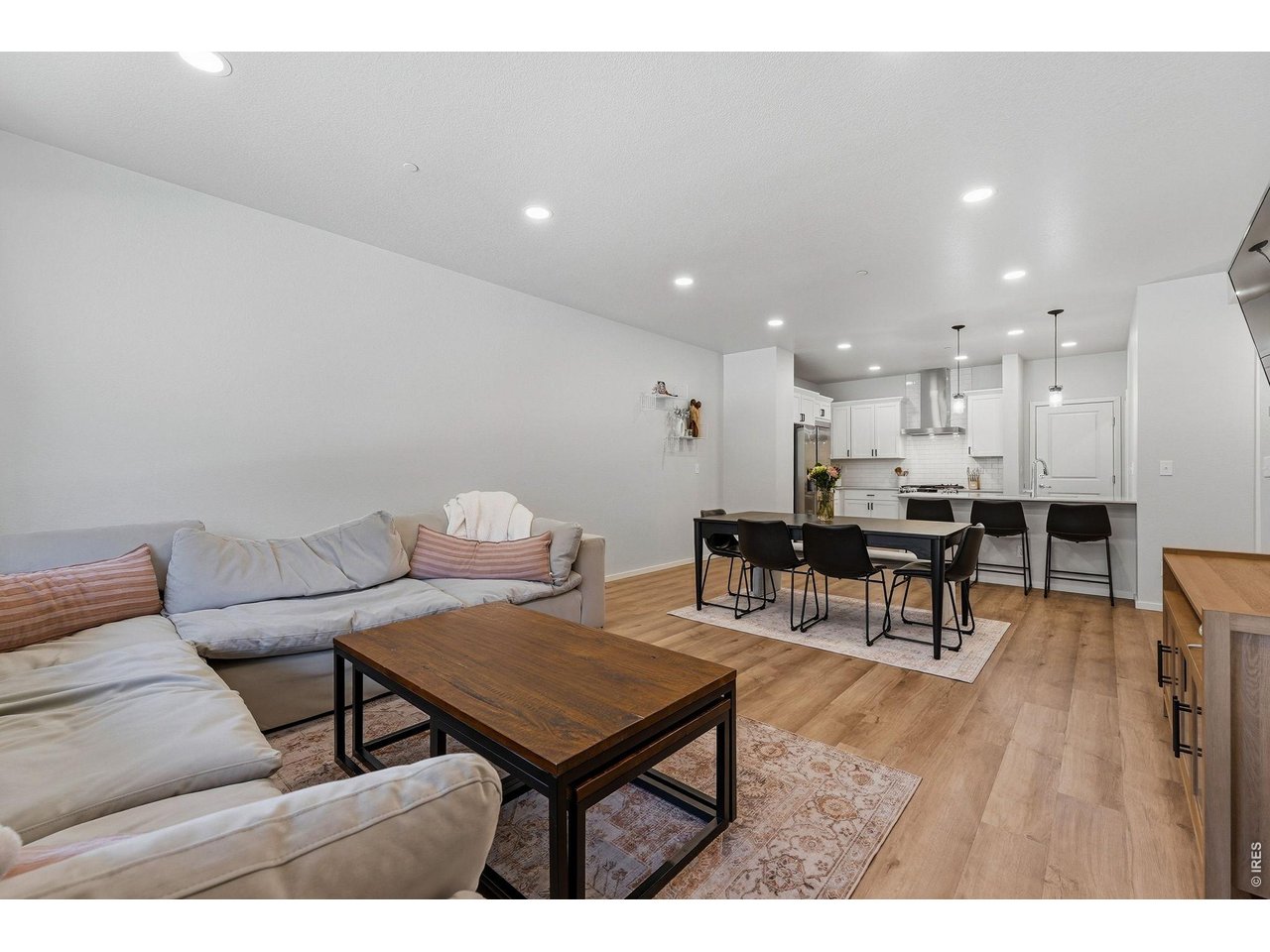 Bright open-concept floor plan featuring a generous living room, dining area, and stylish kitchen 