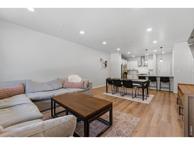 Property Photo 4 Bright open-concept floor plan featuring a generous living room, dining area, and stylish kitchen 