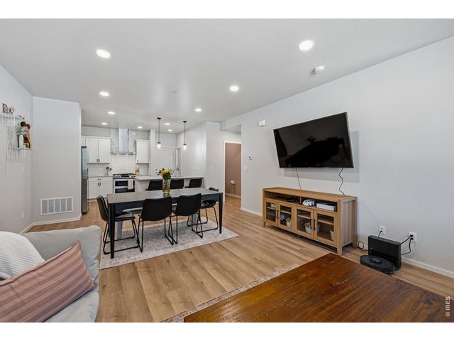 Property Photo 5 Bright open-concept floor plan featuring a generous living room, dining area, and stylish kitchen 