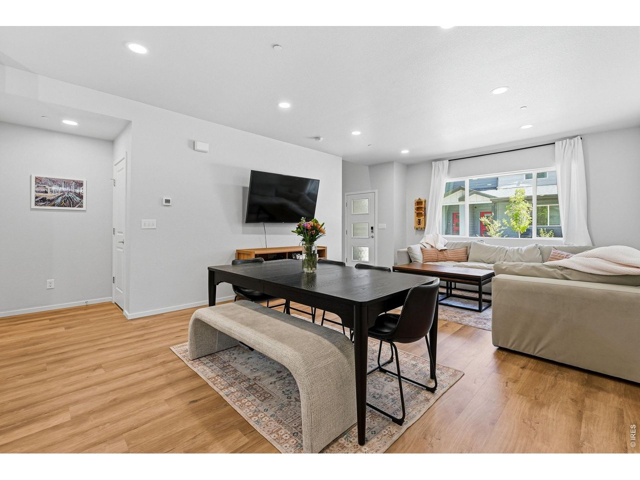 Bright open-concept floor plan featuring a generous living room, dining area, and stylish kitchen 