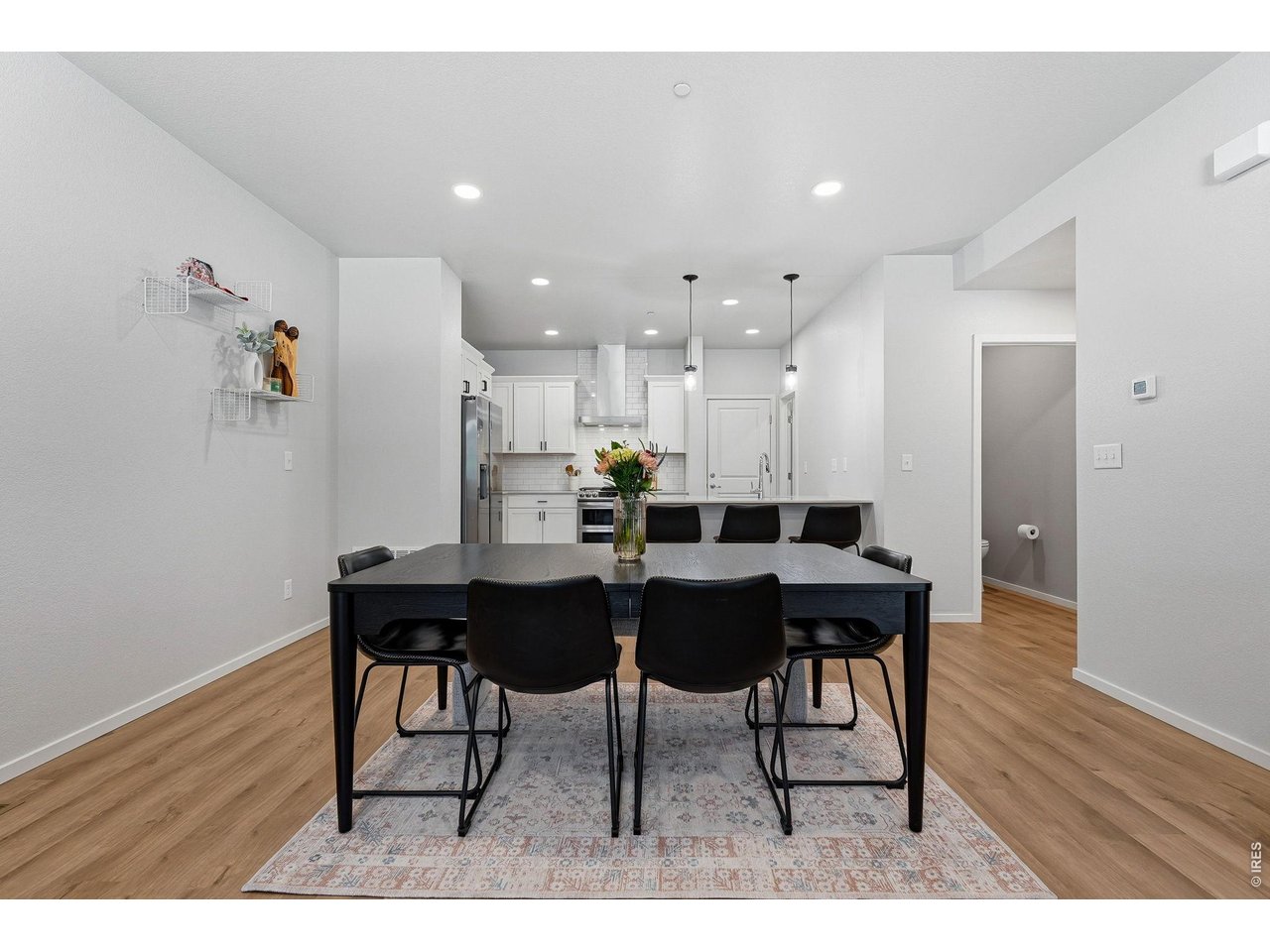 Bright open-concept floor plan featuring a generous living room, dining area, and stylish kitchen 