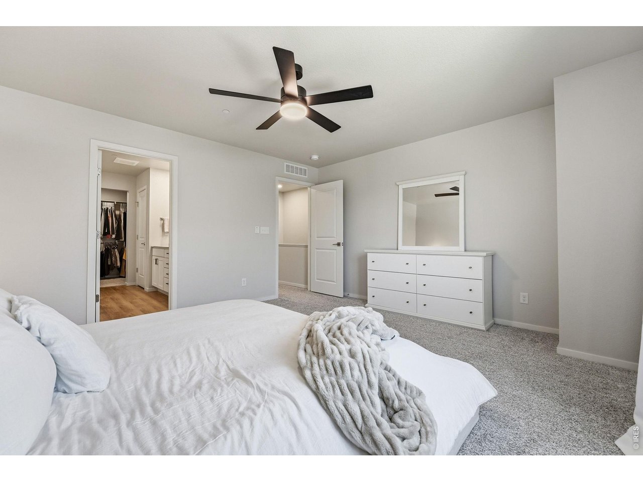 Primary suite offers a walk-in closet and private bath
