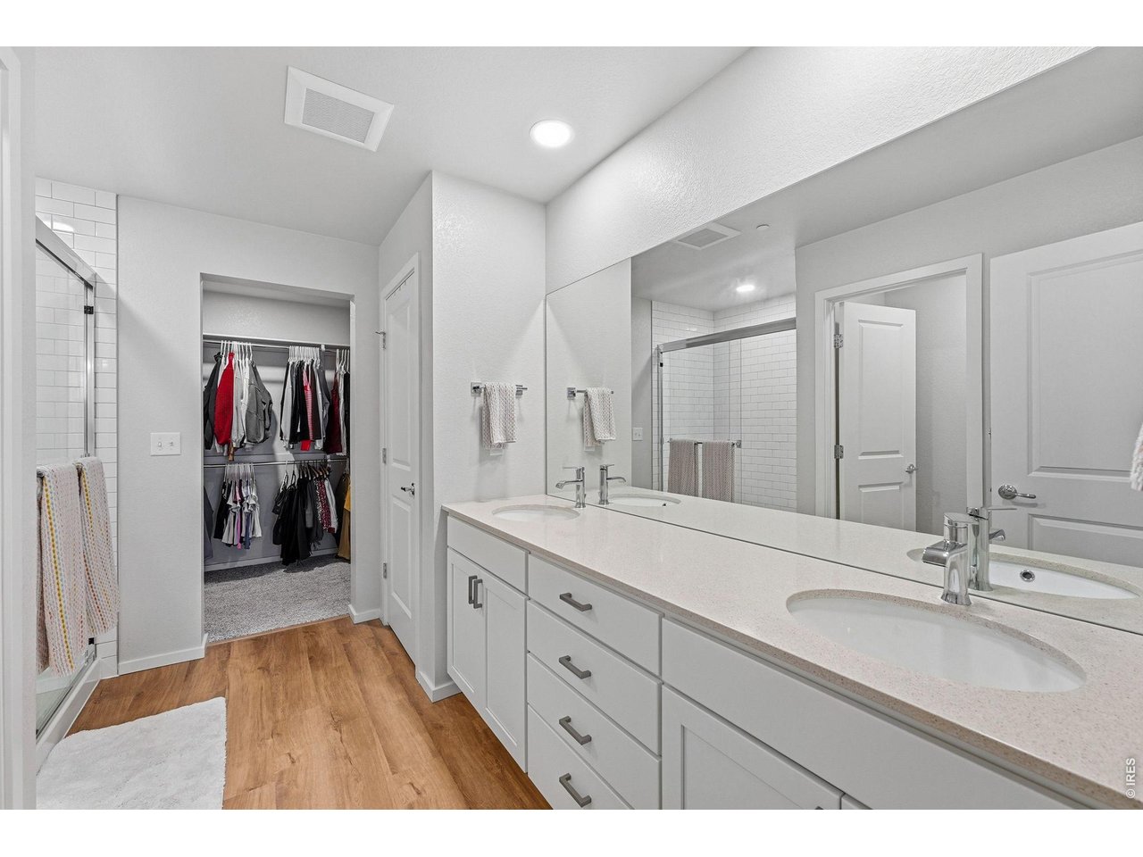 Primary suite offers a walk-in closet and private bath