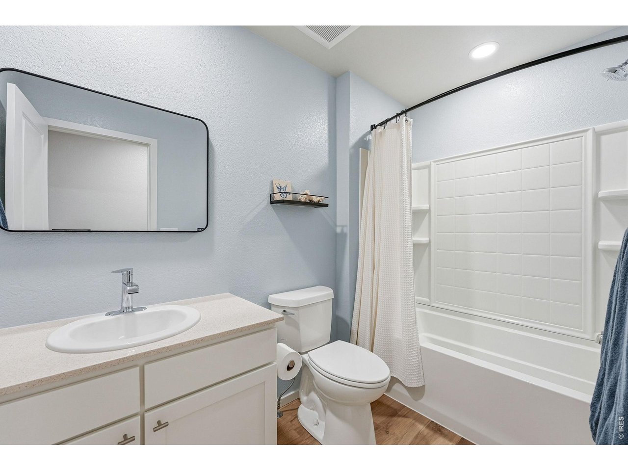 Two additional bedrooms feature walk-in closets and share a full bath