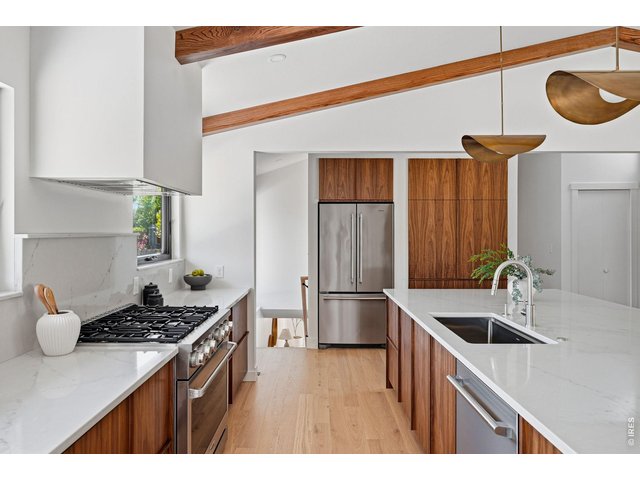 Property Photo 6 Custom walnut cabinetry with integrated walnut pulls & 36" Thor gas range