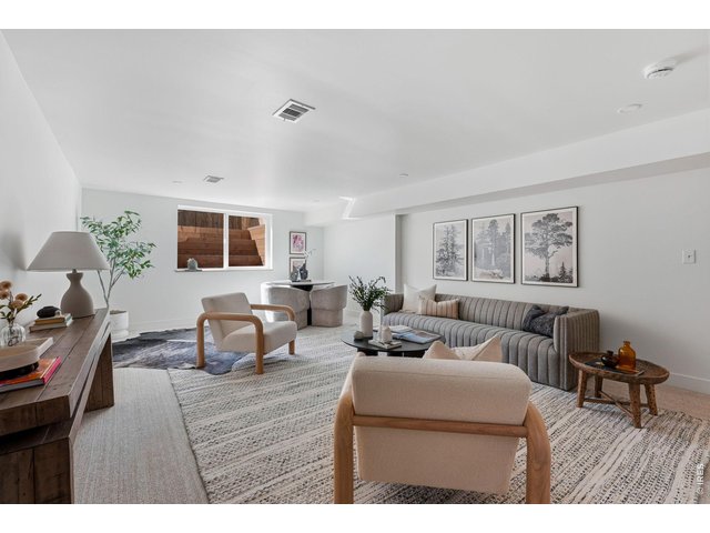 Property Photo 32 Oversized egress window floods the basement rec room with natural light, creating a bright and inviting space
