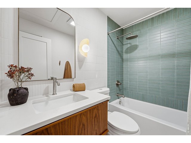 Property Photo 31 Main bathroom with designer tile work/details & custom walnut vanity