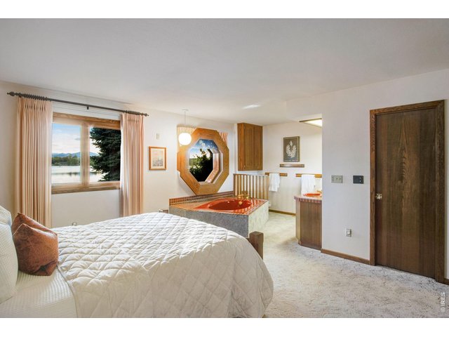 Property Photo 31 Primary bedroom - notice window placed so you can wake up to lake views