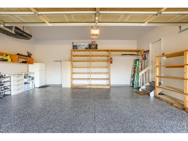 Property Photo 30 Garage with epoxy flooring/built-in shelving/hot and cold water spigots