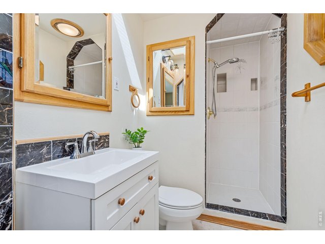 Property Photo 18 Charming primary bath with skylight and stained glass window.
