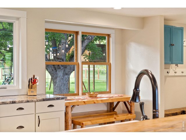 Property Photo 12 The breakfast bar offers a warm and inviting view, perfectly capturing the lovely atmosphere of this home.