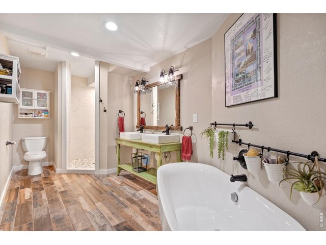 Property Photo 23 The primary bathroom has been beautifully remodeled to feature a custom vanity, a spacious walk-in shower, and an elegant soaking tub.