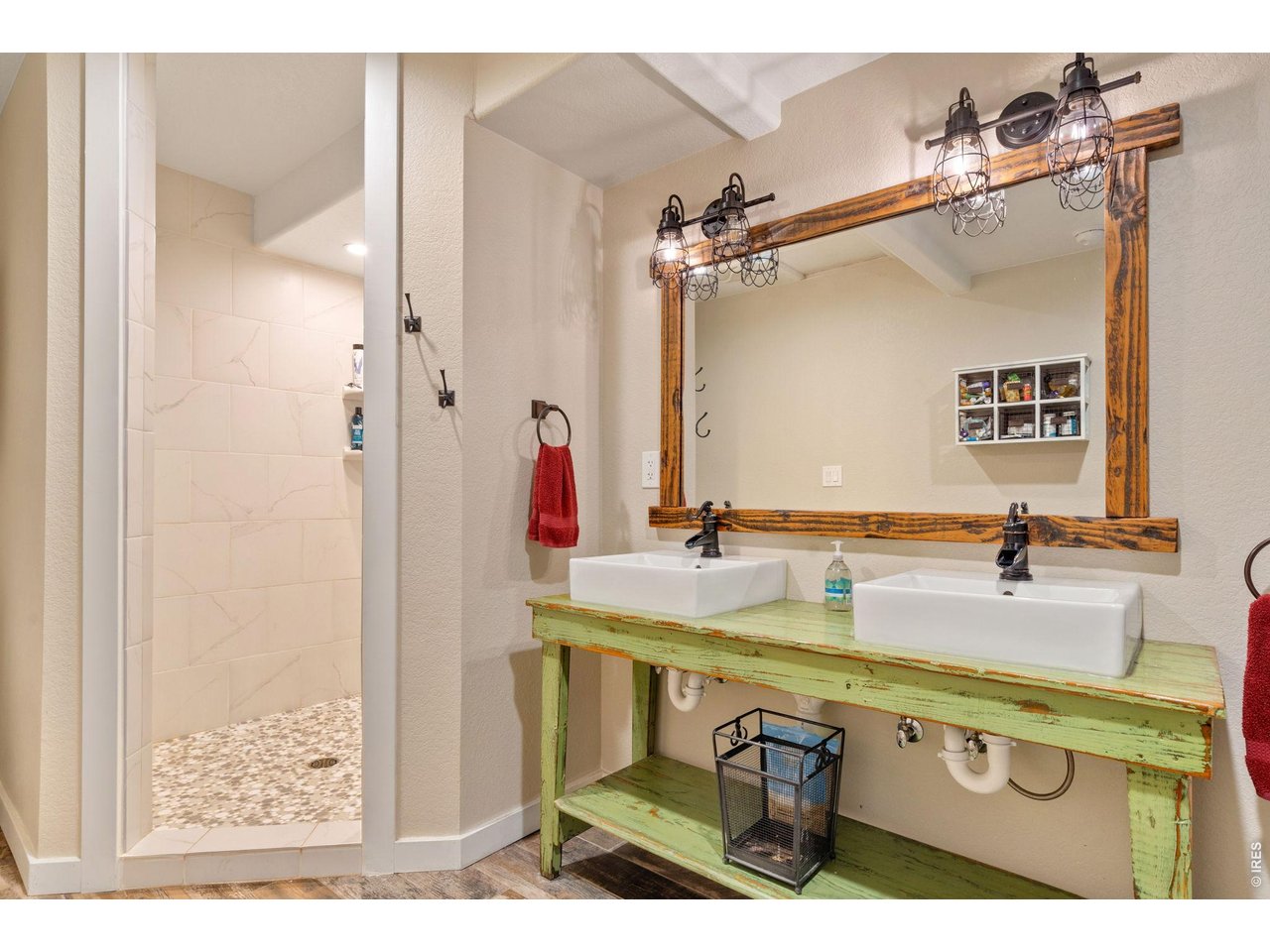Stunning farmhouse-inspired primary bathroom featuring a spacious double vanity and an expansive walk-in shower.