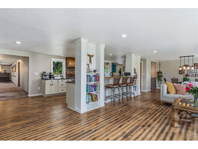 Property Photo 8 Inviting and comfortable open, this beautifully remodeled floor plan is perfect for gathering, featuring durable engineered hardwood flooring for easy maintenance.