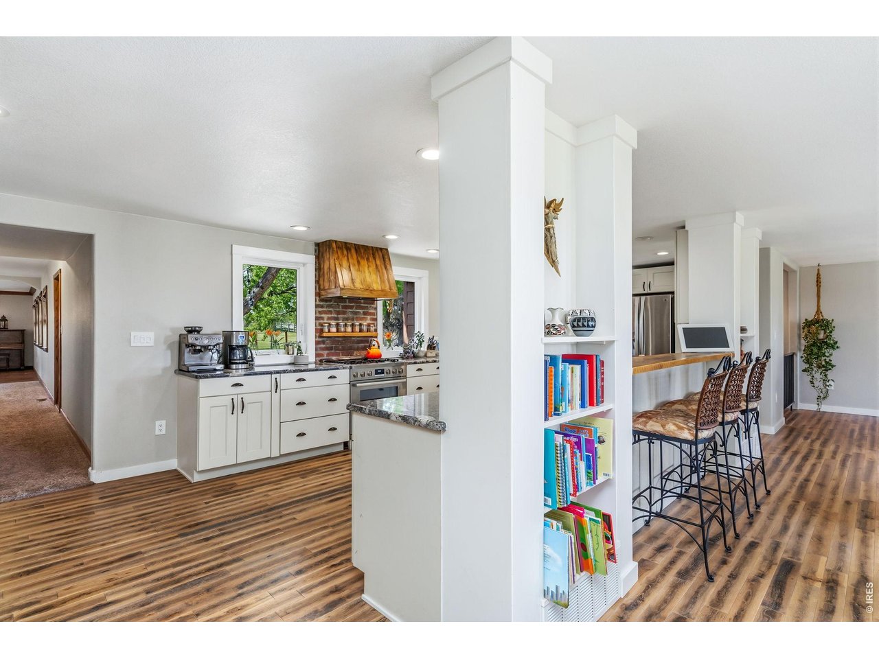 Back at the front door entrance, to your right you see into the kitchen, living, dining rooms and down the hall to the Family Room 