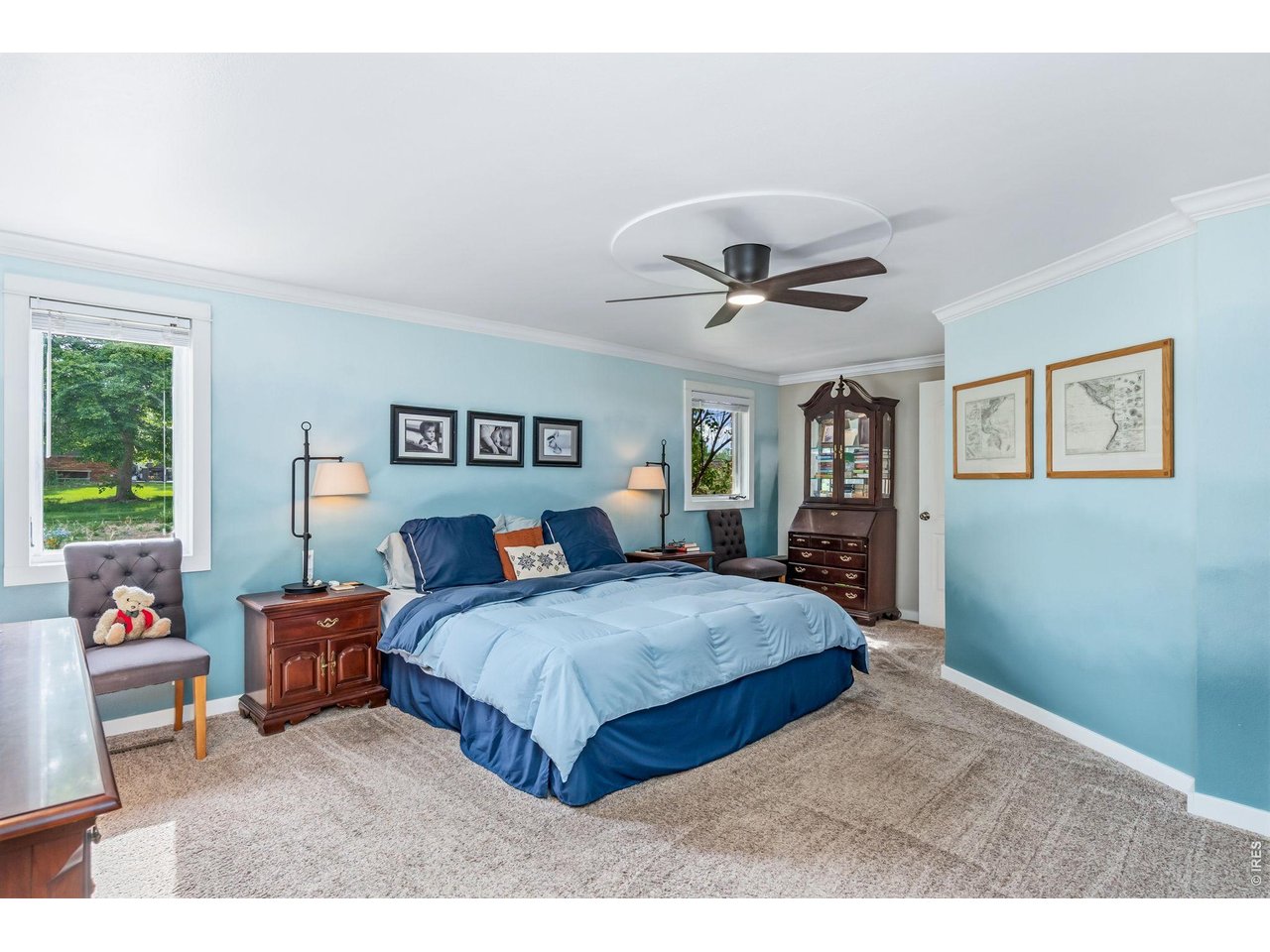 Spacious primary bedroom suite features a tranquil retreat atmosphere, complete with picturesque views of the pollinator garden.