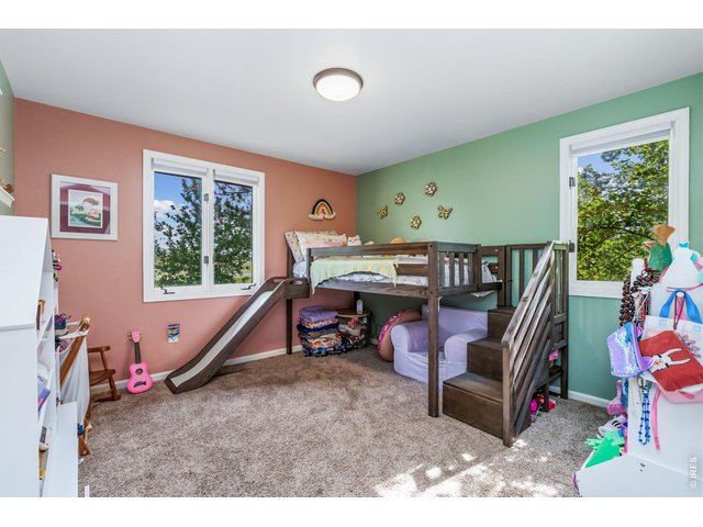 Property Photo 28 Third bedroom is 13.6 x 10 and offers scenic view of the pollinator garden