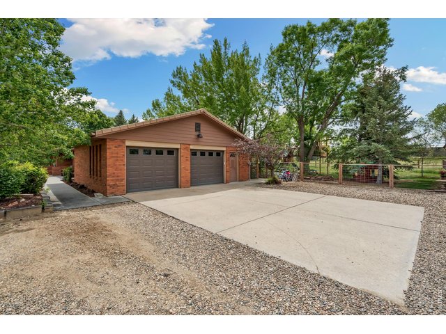 Property Photo 5 Welcome to this inviting home with an expansive driveway that offers plenty of parking for residents and guests alike.