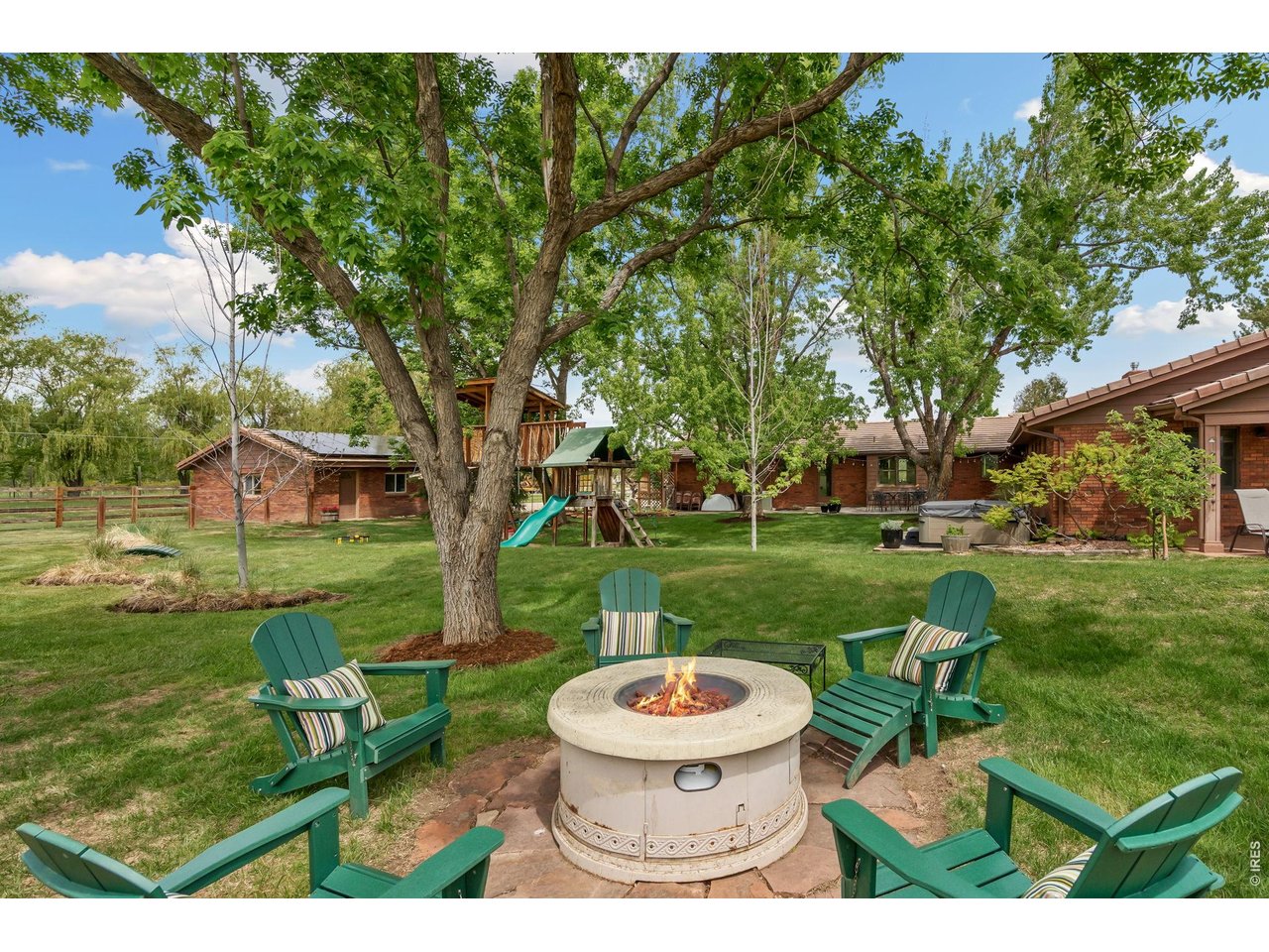 Plan those summer events around the firepit. This inviting backyard is perfect for hosting memorable gatherings, roasting s'mores, and enjoying cozy evenings under the stars. 