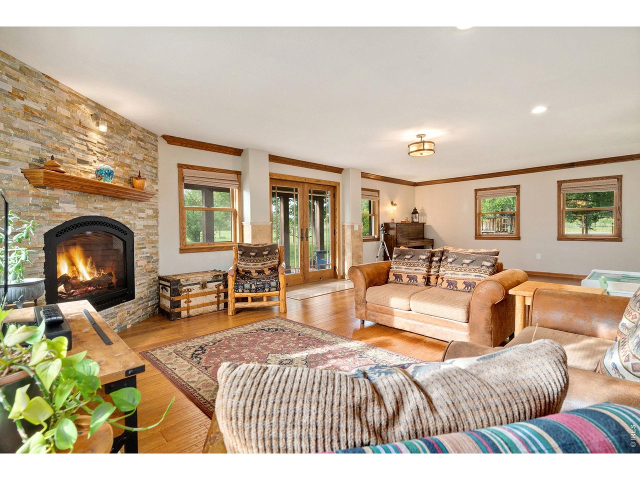 Grand multi-functional family room (23.8' x 16.4') featuring lovely views of the gardens, backyard, and firepit area.