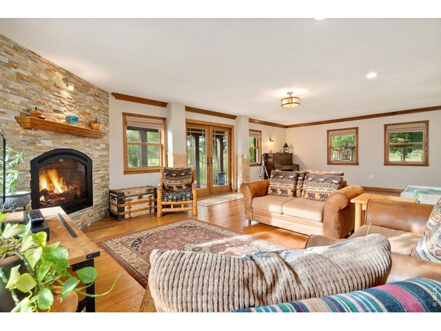 Property Photo 30 Grand multi-functional family room (23.8' x 16.4') featuring lovely views of the gardens, backyard, and firepit area.