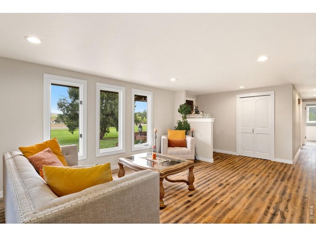 Property Photo 7 Enter into this bright and inviting living room - featuring an open-concept layout that seamlessly connects to the surrounding living spaces