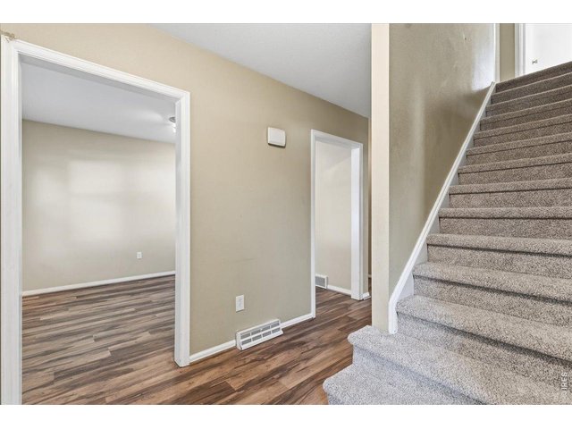 Property Photo 4 Entryway showing the Vinyl Plank Flooring and brand new carpet.