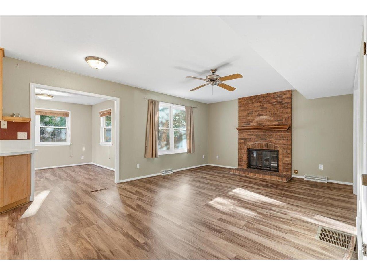 Property Photo 8 Family Room with Fireplace. Attached sunporch or Coffee nook - you decide!