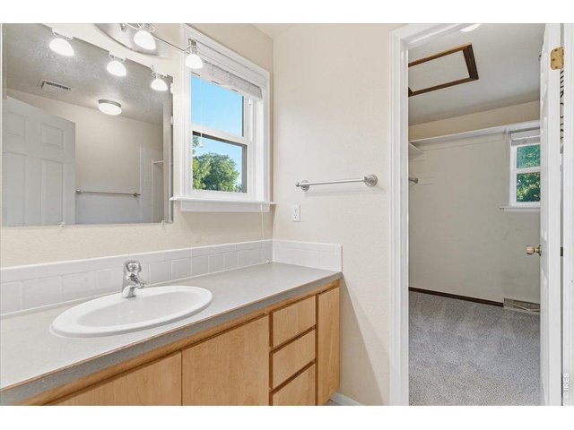 Property Photo 20 Ensuite primary bath and walk-in closet with window
