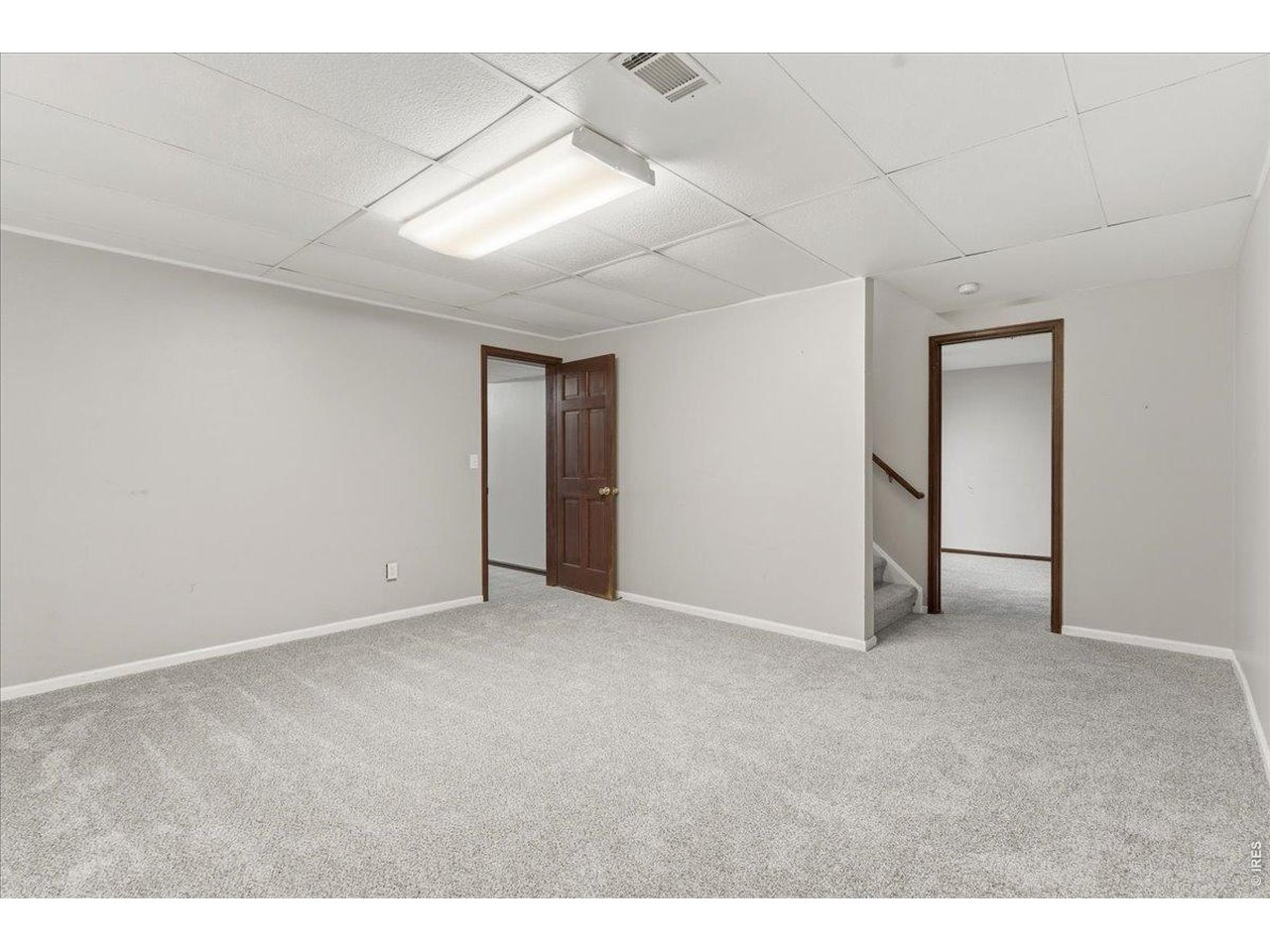Property Photo 26 Basement Rec room looking left into the Laundry and right into the nonconforming 5th bedroom or office.