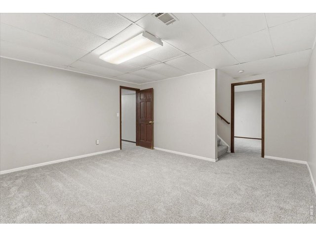 Property Photo 26 Basement Rec room looking left into the Laundry and right into the nonconforming 5th bedroom or office.