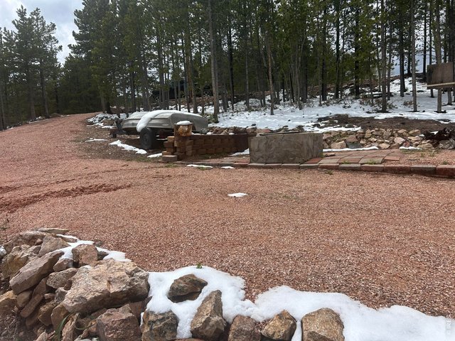 Property Photo 6 Gravel driveway with dual-level camping areas 