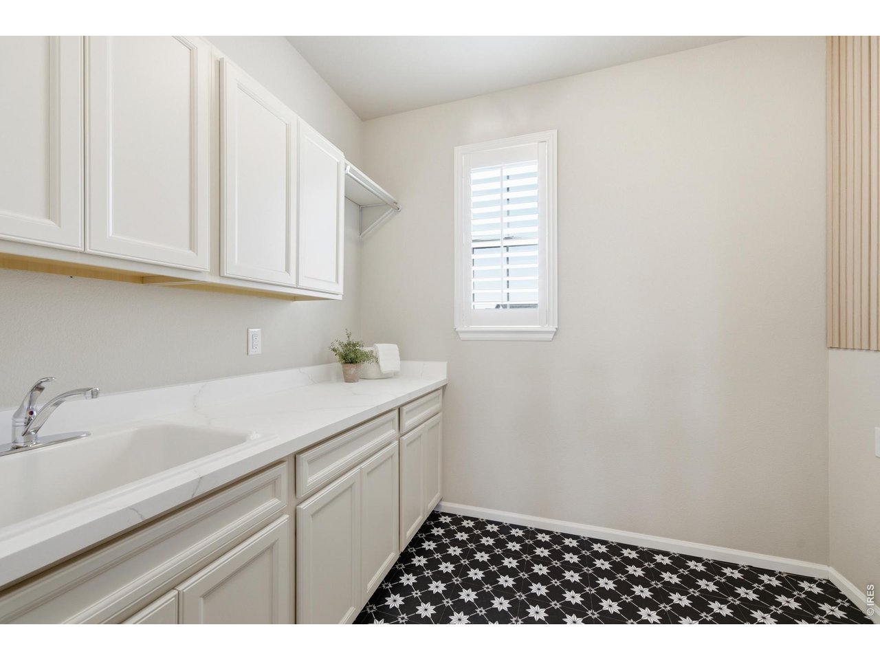 Property Photo 21 The large laundry room includes a folding table, sink and cabinetry
