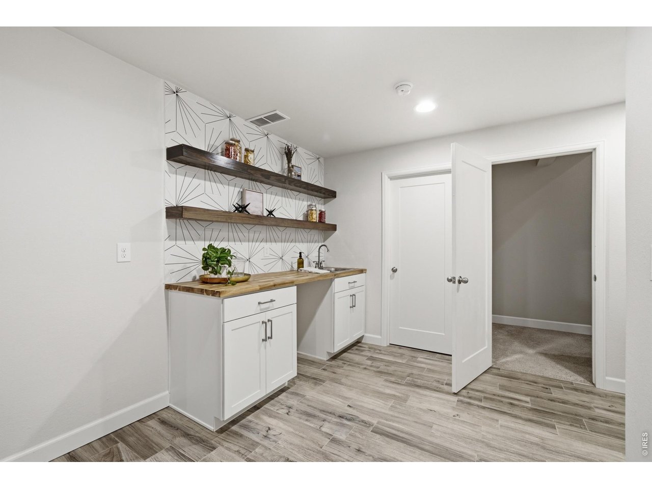 Property Photo 27 The basement welcomes you with a beautifully designed wetbar