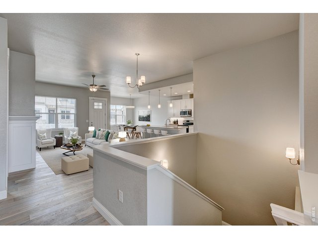 Property Photo 16 Stairs to the full, finished basement providing rec room, living room & 2 additional bedrooms! 