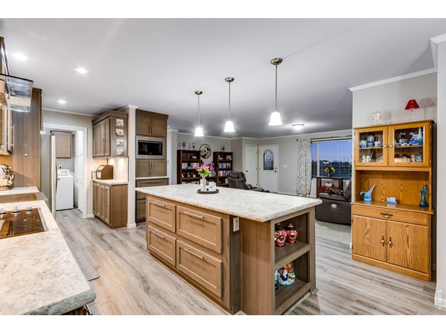Property Photo 19 Plenty of cabinets, soft-close uppers, crown molding, appliance garage, full tile backsplash