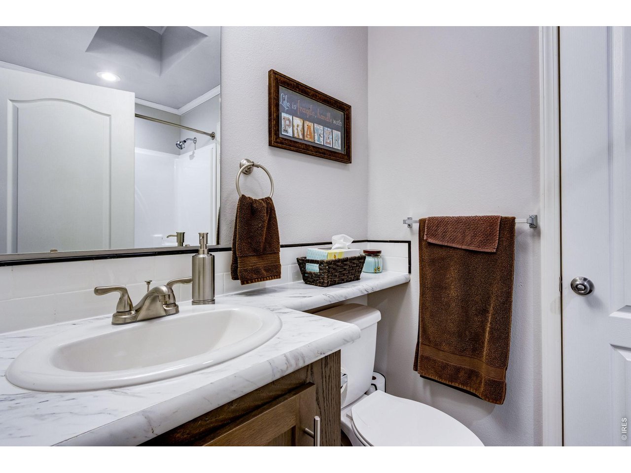 Property Photo 33 Jack and Jill full bath features a skylight and lifted vanity 
