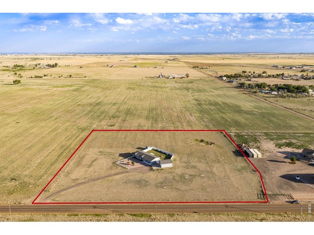 Property Photo 2 Experience the freedom of rural Northern Colorado on 5 fenced acres with incredible Rocky Mountain views, Ag zoning, NO HOA, and NO Metro Tax. 