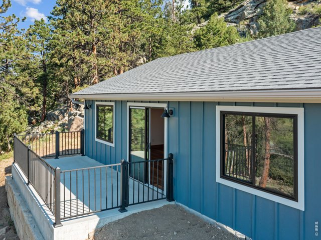 Property Photo 2 New roof, siding, windows, concrete, gutters, driveway, cistern pump, and deck railing
